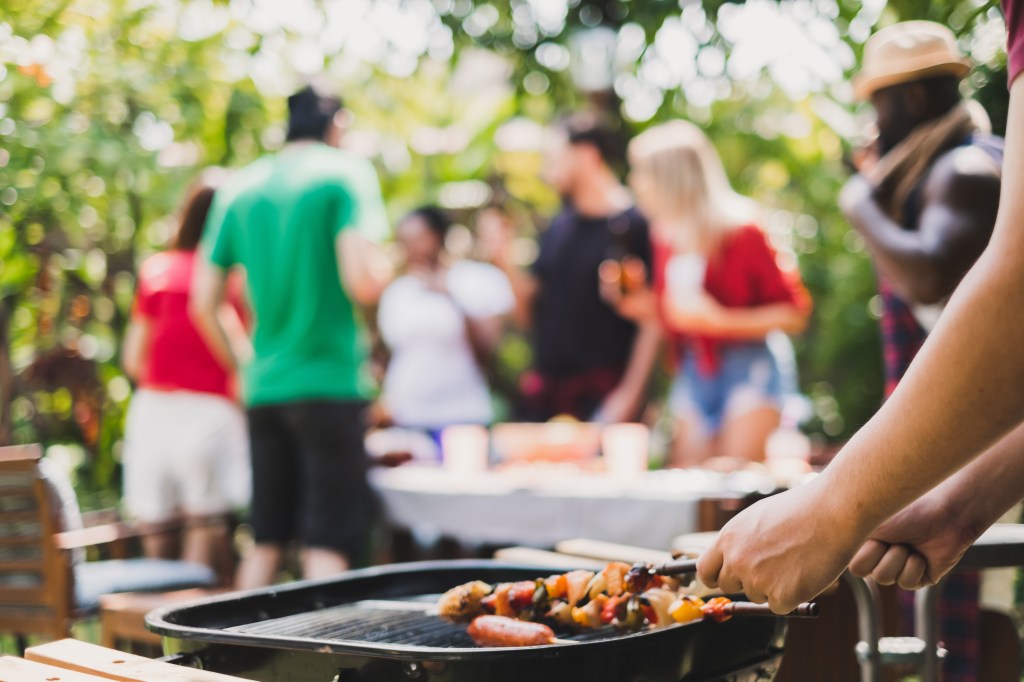 Group of diversity people having barbecue/barbeque party at home, cooking grilled meat/beef for lunch, happy friends party lifestyle concept