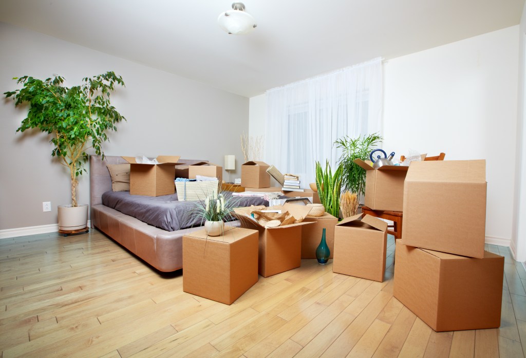 Moving boxes in new house. Real estate concept.
